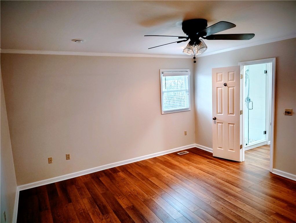 1809 Busby Road Anderson, SC 29626 - Photo 12 of 43 This spacious bedroom features lustrous hardwood flooring and an inviting ambiance.