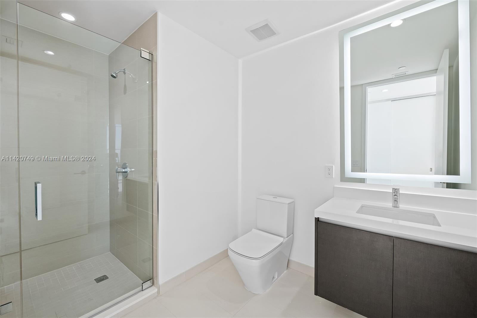 Park West Miami, FL 33132 - Photo 35 of 88 a bathroom with a shower sink vanity and mirror