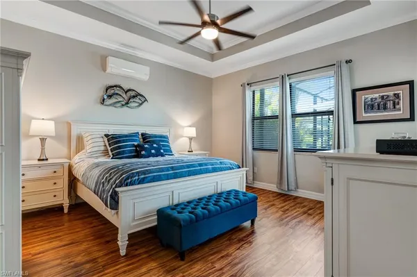 a bedroom with a large bed and a chandelier