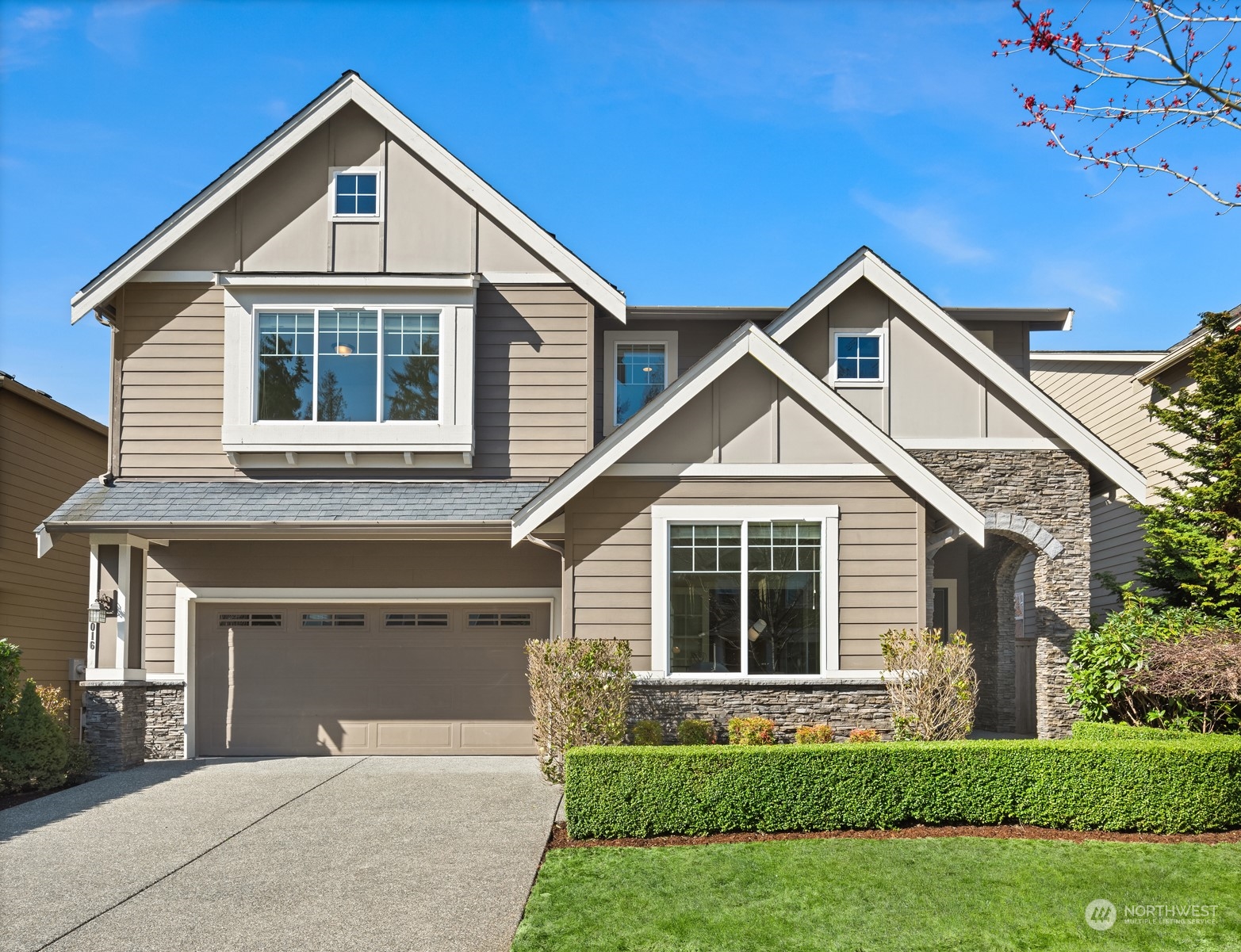 a front view of a house with a yard and garage