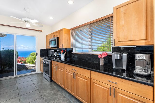 a living room with furniture a ceiling fan and a rug