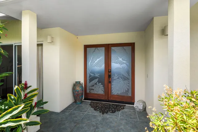 a bedroom with a bed a couch and large window