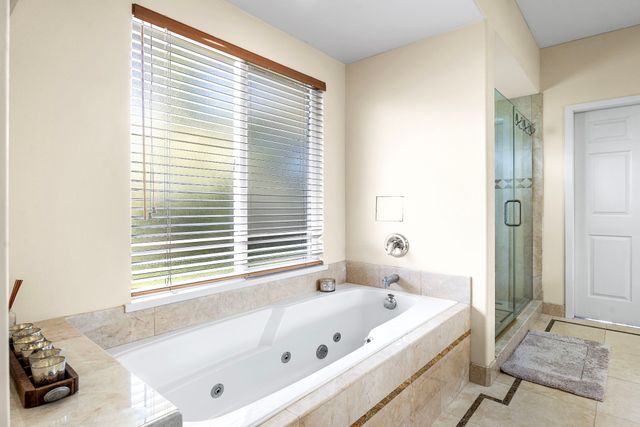 a large bed sitting in a bedroom next to a window