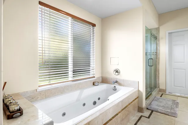 a large bed sitting in a bedroom next to a window