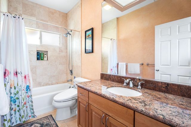 a bed room with a bed window and a chair