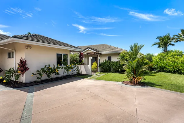 a view of a house with backyard sitting area and garden