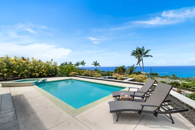 a view of swimming pool with outdoor seating and plants