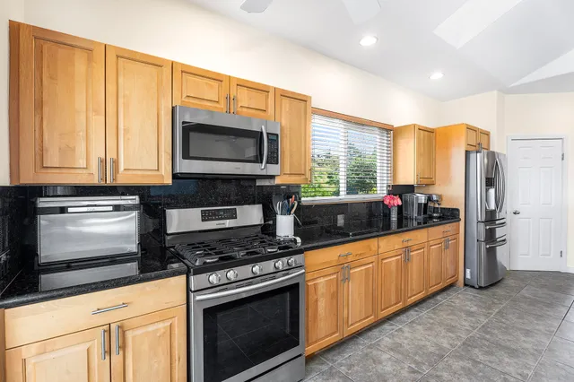a kitchen with granite countertop a sink and cabinets