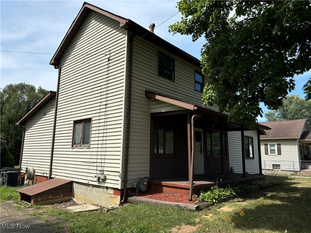 5164 Rutledge Street Southeast Dennison, OH 44621 - Photo 2 of 14 Rear view of house featuring a yard