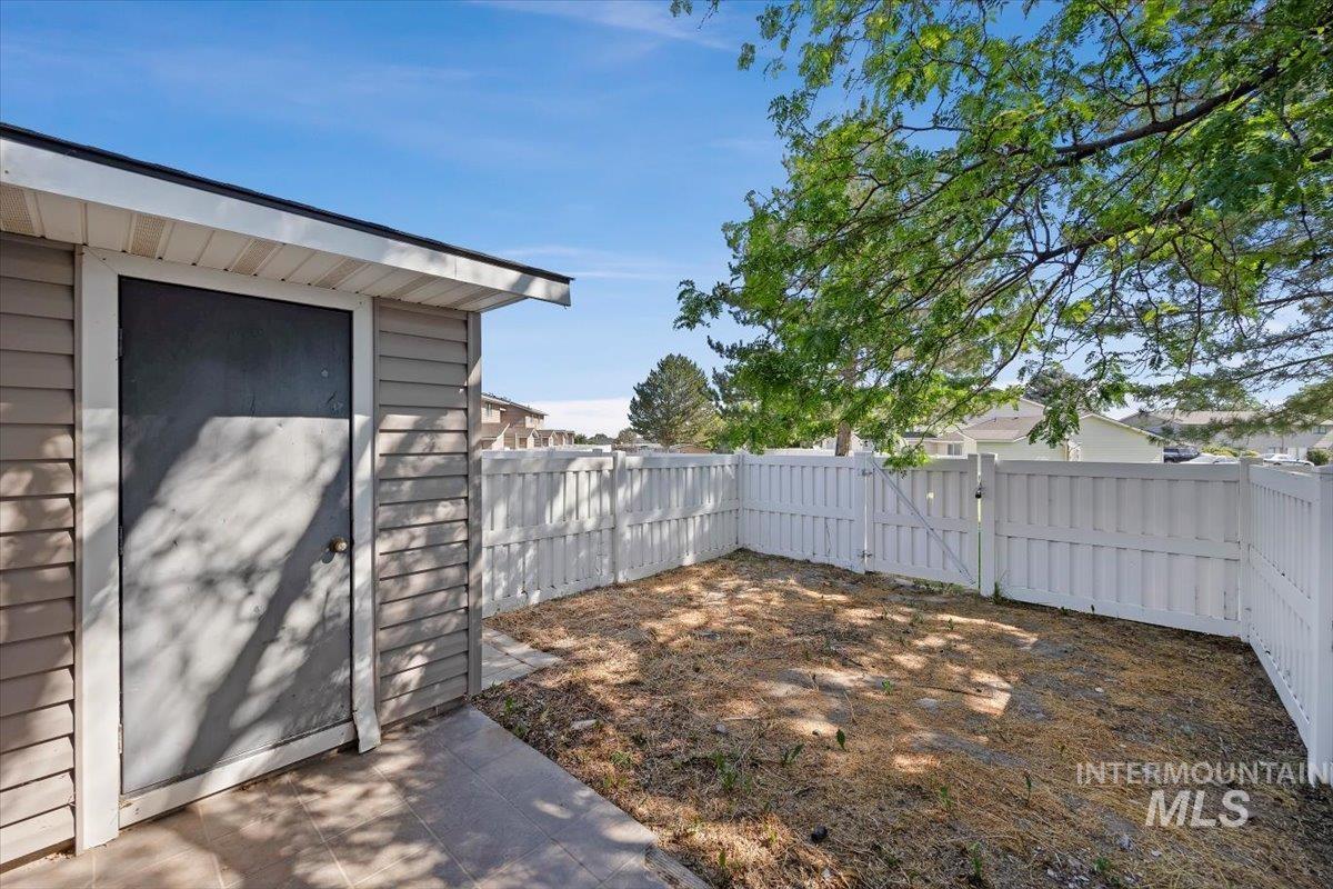 259 Pheasant Road, Unit 84 Twin Falls, ID 83301 - Photo 21 of 25 Attached storage shed with horizontal siding and a full privacy fence