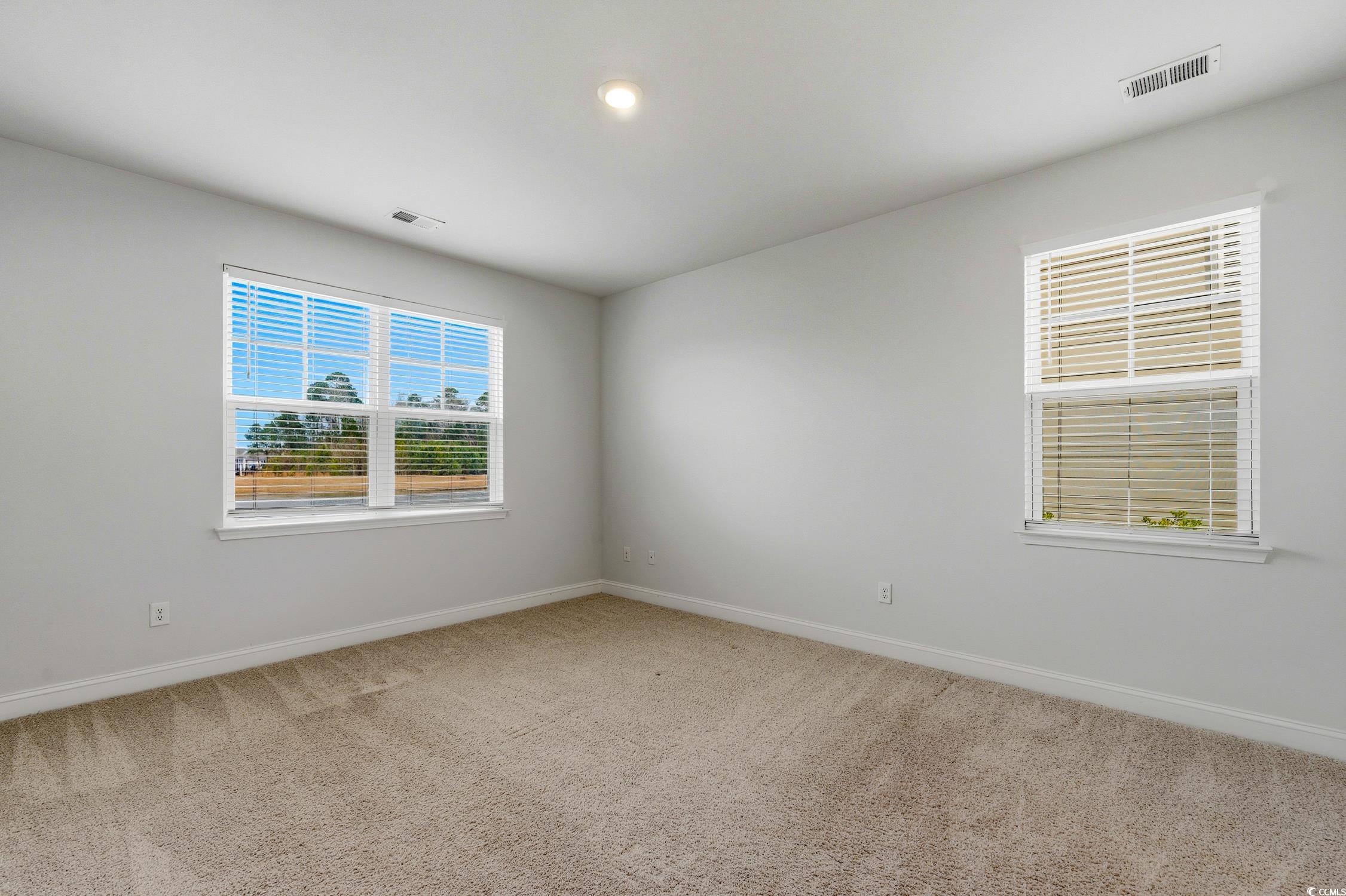 3083 Gillham Loop Myrtle Beach, SC 29588 - Photo 11 of 34 Kitchen with appliances with stainless steel finishes, white cabinets, light stone counters, light wood-type flooring, and tasteful backsplash