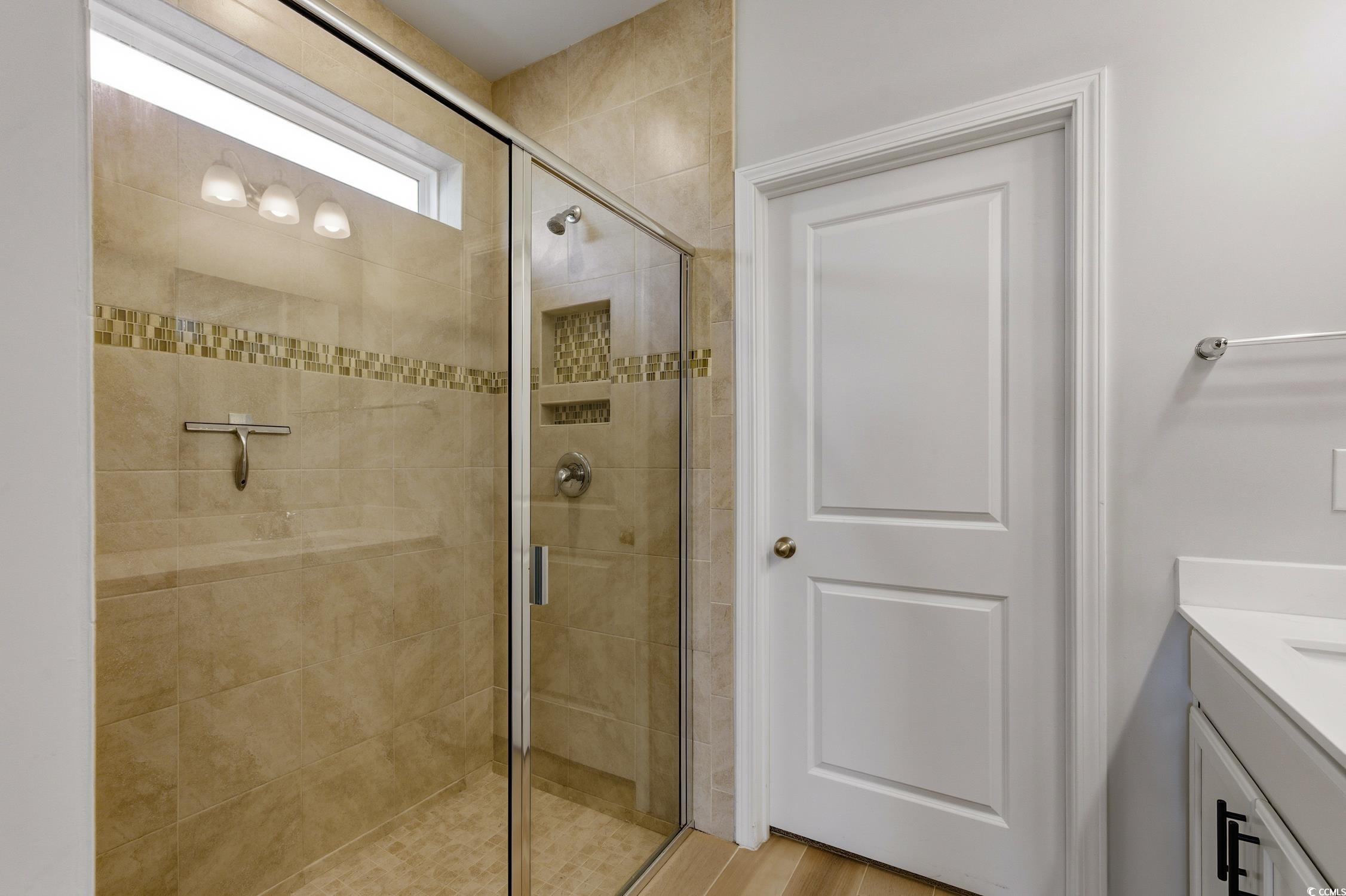3083 Gillham Loop Myrtle Beach, SC 29588 - Photo 12 of 34 Empty room featuring dark wood-style floors, a water view, a chandelier, and healthy amount of natural light