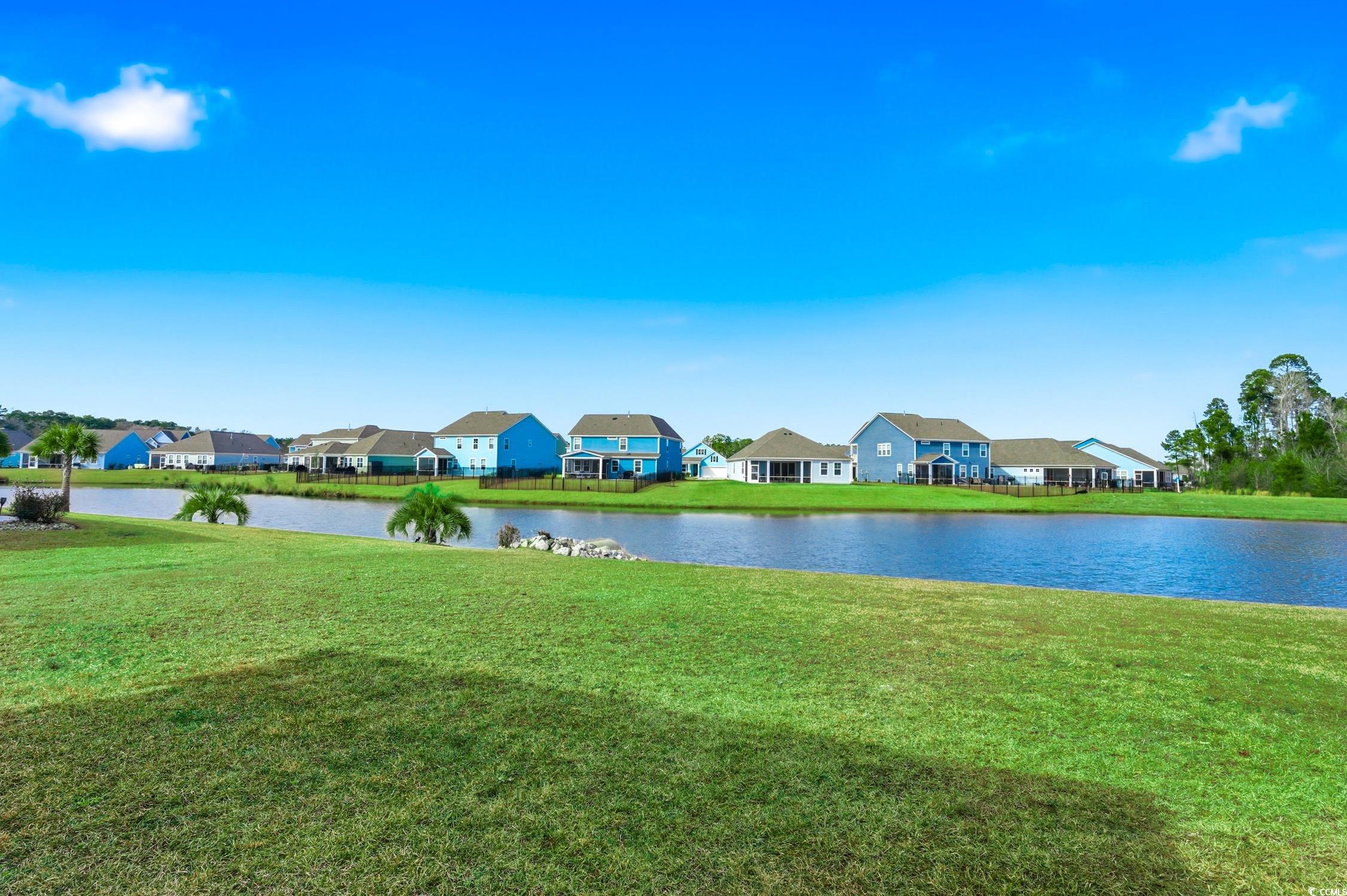 3083 Gillham Loop Myrtle Beach, SC 29588 - Photo 30 of 34 View of green lawn with a ceiling fan, a water view, a residential view, and a sunroom