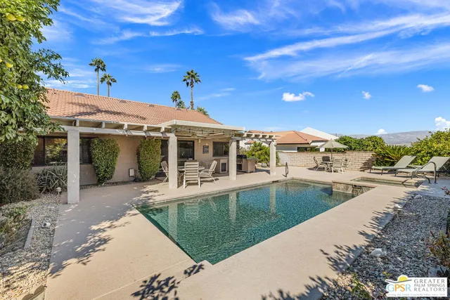 a view of a house with pool porch and sitting area