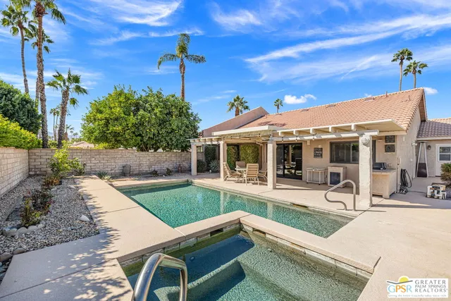 a view of a house with a yard and sitting area