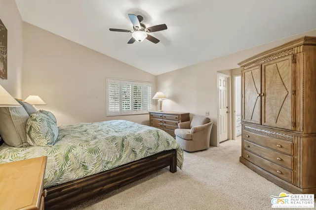 a bedroom with a bed dresser and wooden floor