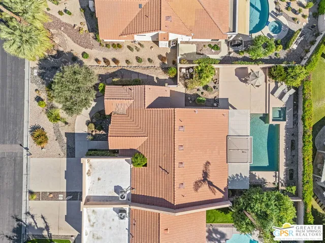 an aerial view of a house with yard and parking