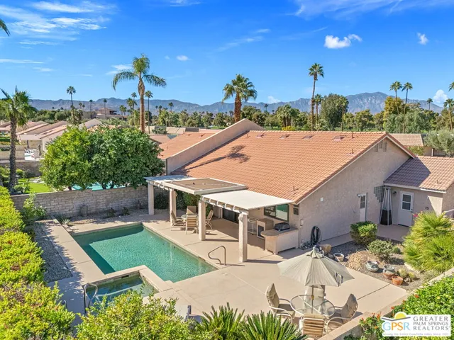 a view of a patio with a table and chairs