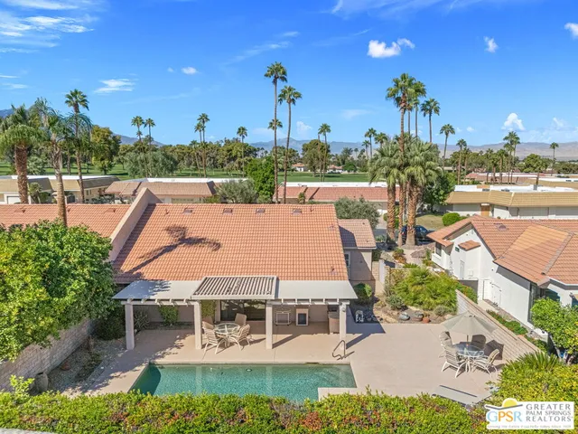 a view of a swimming pool and outdoor seating