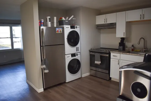 a utility room with sink dryer and washer