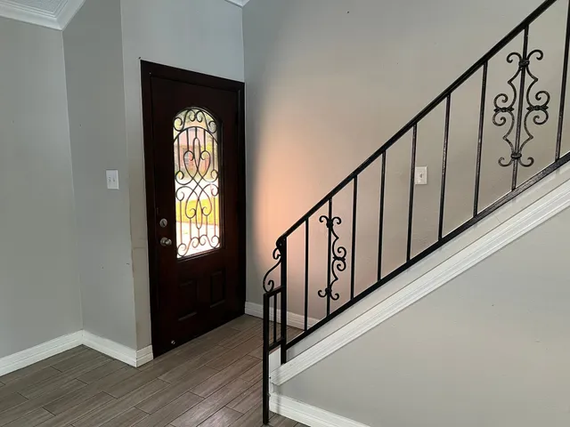 a view of entryway with wooden floor and stairs