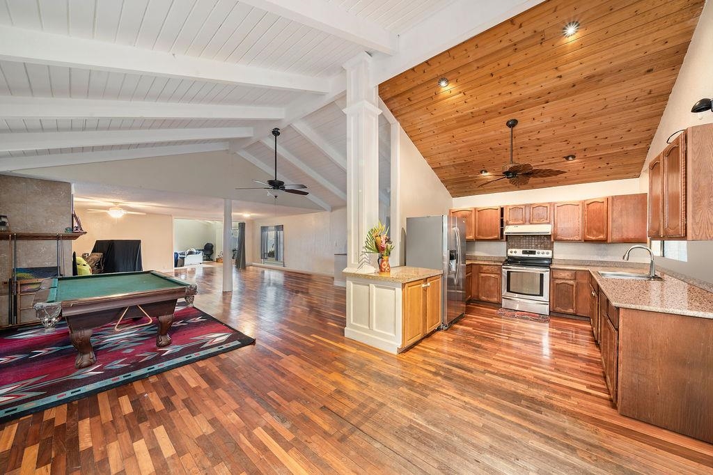 12 Upper Kimo Drive Kula, HI 96790 - Photo 12 of 30 a living room with stainless steel appliances kitchen island granite countertop a table chairs and a wooden floor