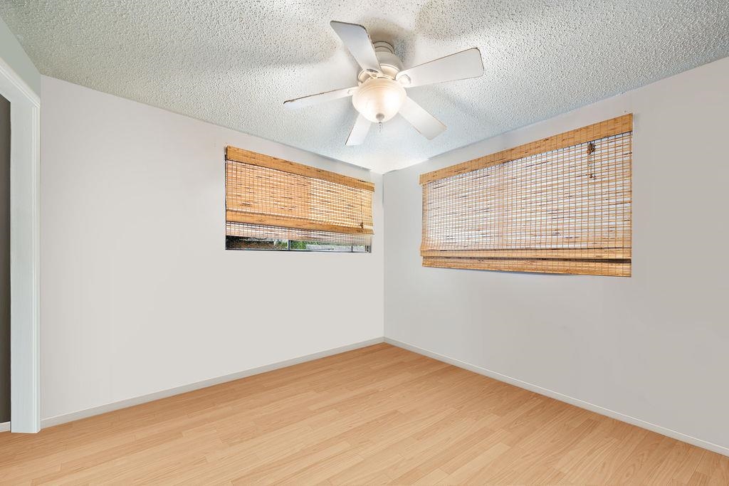 12 Upper Kimo Drive Kula, HI 96790 - Photo 19 of 30 a view of an empty room with wooden floor and a window