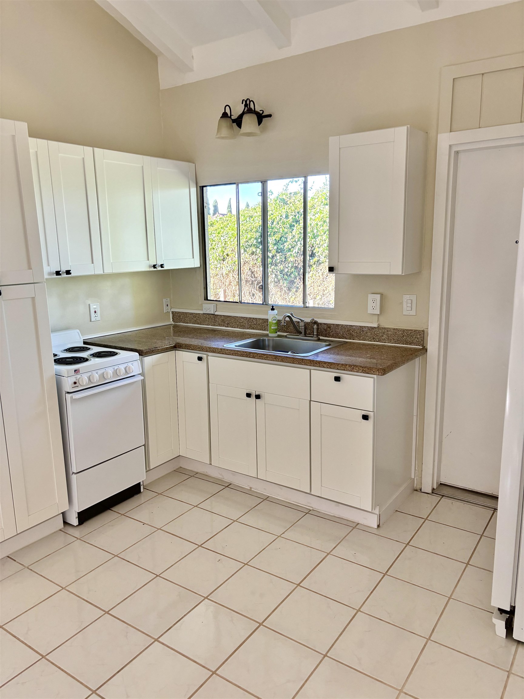 12 Upper Kimo Drive Kula, HI 96790 - Photo 23 of 30 a kitchen with a stove a sink and a refrigerator