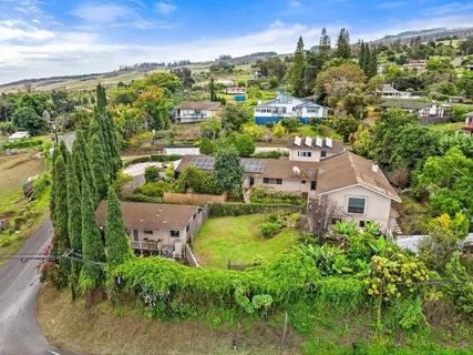 an aerial view of residential houses with outdoor space and street view