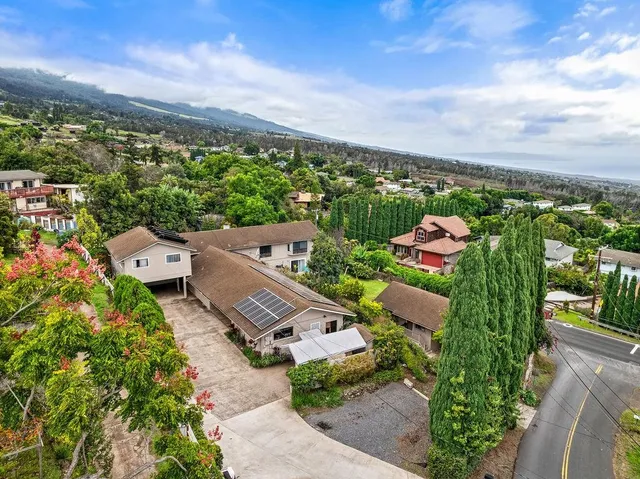 an aerial view of a house with lots of trees