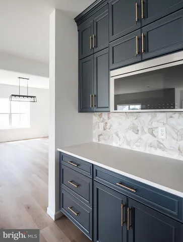 a kitchen with granite countertop wooden cabinets and stainless steel appliances