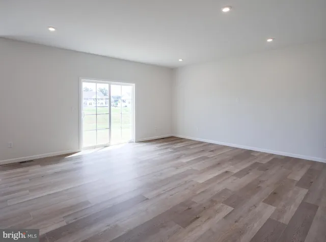 a large kitchen with stainless steel appliances granite countertop a large counter top and a wooden floors