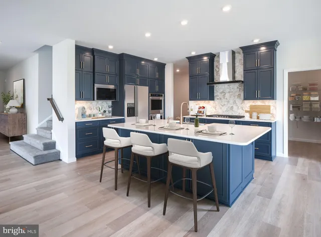 a kitchen with a sink and chairs
