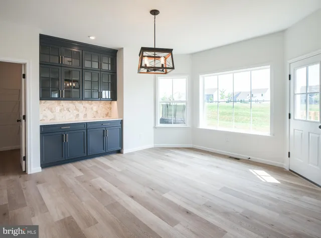 a kitchen with kitchen island granite countertop a sink and a refrigerator