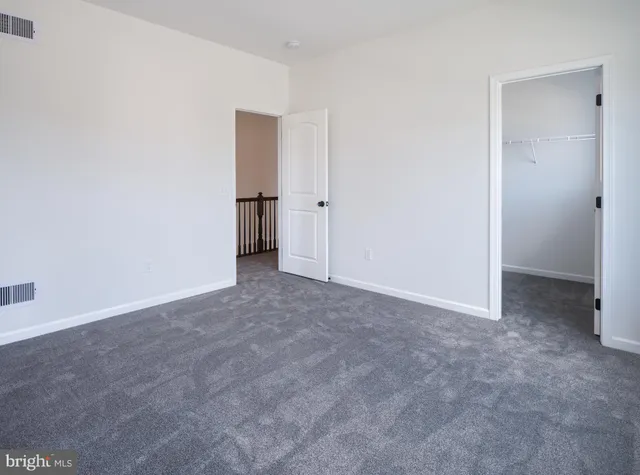 an empty room with an entrance to other room