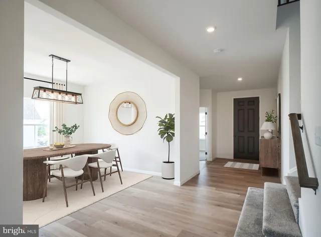 a living room with furniture a window and wooden floor