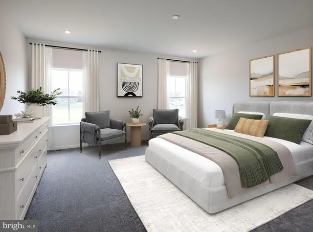 a bedroom with a bed couches chair and a large window