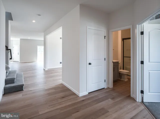 a view of a hallway with wooden floor