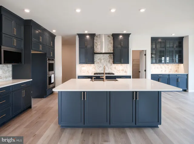 a kitchen with stainless steel appliances a sink and a refrigerator