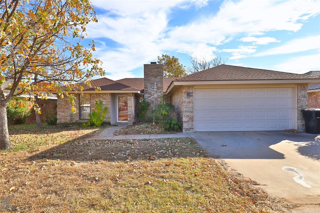 3933 Duke Lane Abilene, TX 79602 - Photo 1 of 1 a front view of a house with a yard and garage
