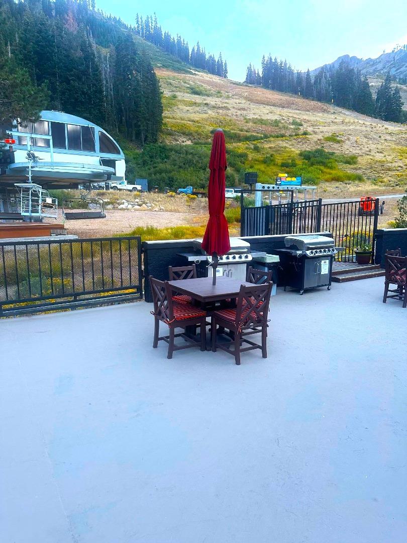 1 Red Wolf Lodge Olympic Valley, CA 96146 - Photo 6 of 10 a backyard of a house with barbeque oven table and chairs