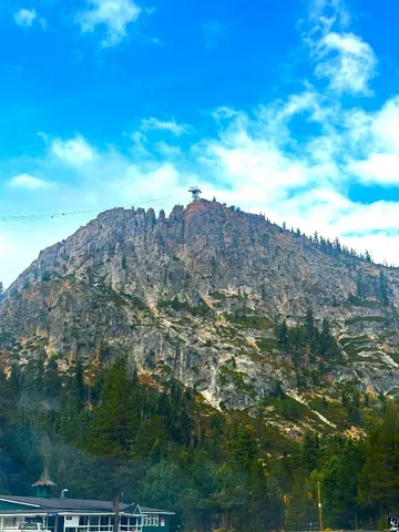 a front view of a building with street view and trees