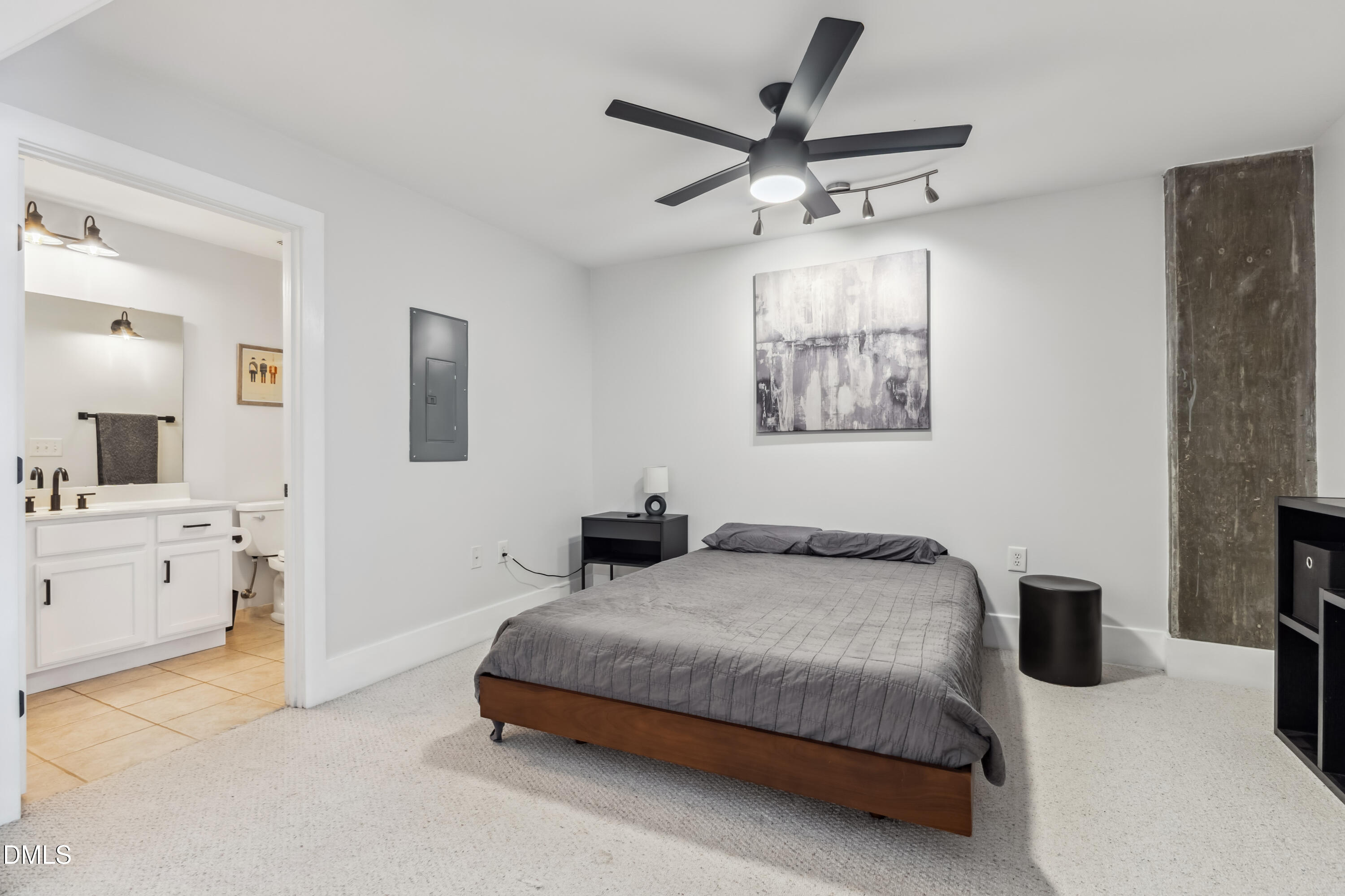 444 South Blount Street, Unit 209 Raleigh, NC 27601 - Photo 11 of 19 a bedroom with a bed and ceiling fan
