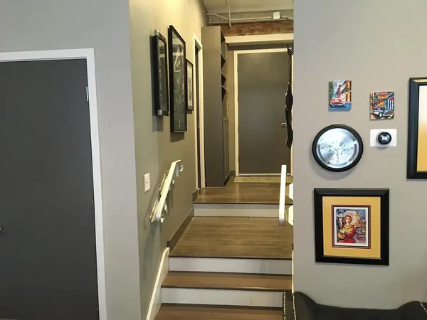 a view of a hallway with wooden floor and a large window