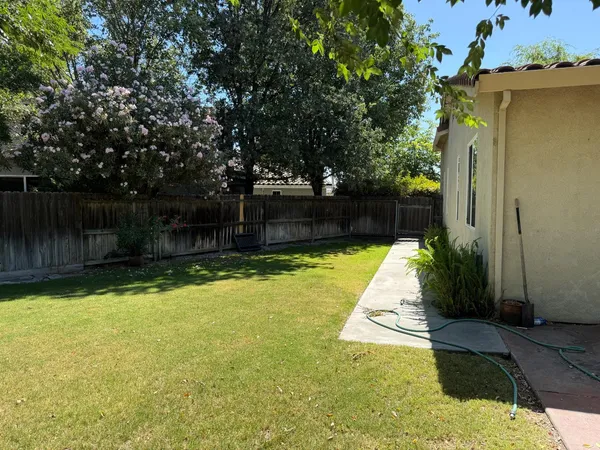 an empty room and chandelier fan