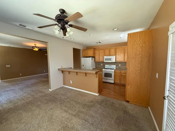 a view of room with window and ceiling fan