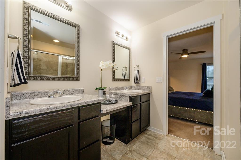 4626 Gibbons Link Road Charlotte, NC 28269 - Photo 15 of 20 a en suite bathroom with a double vanity sink and a mirror