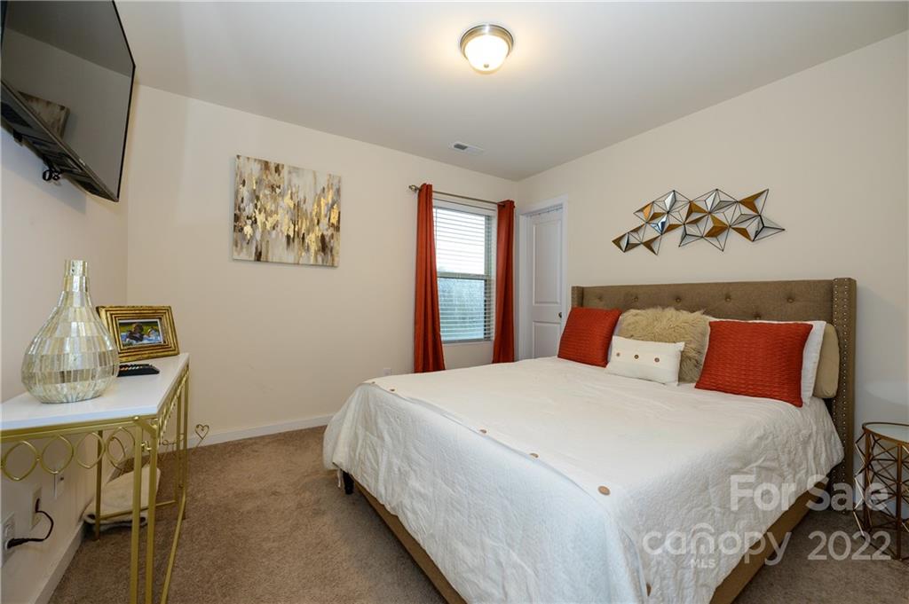 4626 Gibbons Link Road Charlotte, NC 28269 - Photo 18 of 20 a bedroom with a bed and a window