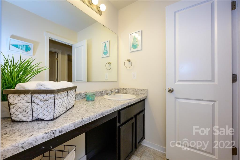 4626 Gibbons Link Road Charlotte, NC 28269 - Photo 20 of 20 a bathroom with a granite countertop sink and a mirror