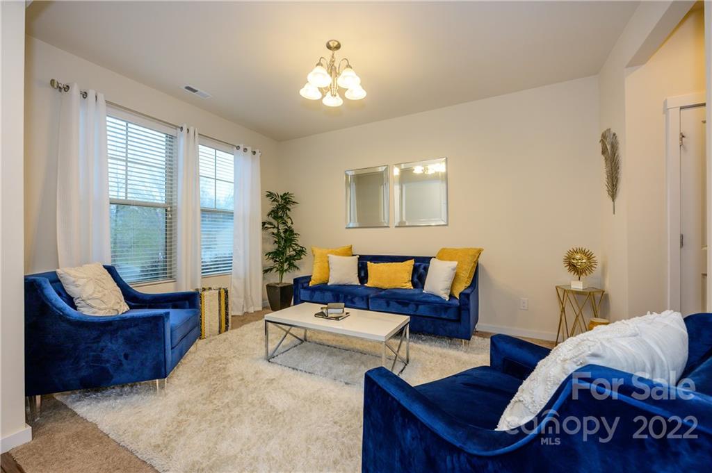 4626 Gibbons Link Road Charlotte, NC 28269 - Photo 3 of 20 a living room with furniture and a potted plant